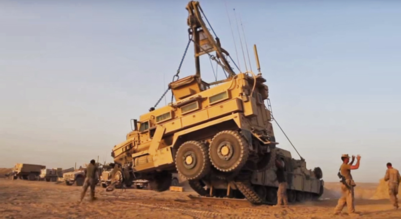 Illustration for article titled It Takes Three Extreme Machines To Flatbed An MRAP With A Blown Tire